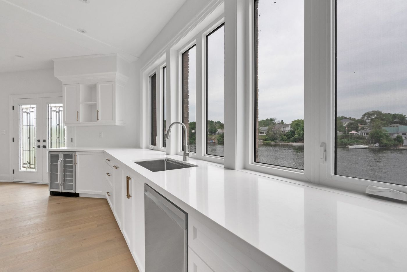 Kitchen sink under a wall of river-view windows